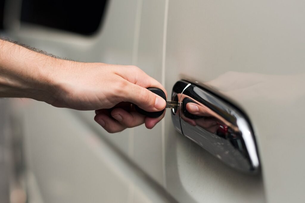 Hand opening a car door during a vehicle lockout