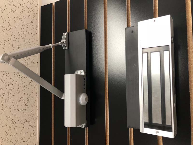 Commercial locksmith servicing a business door lock