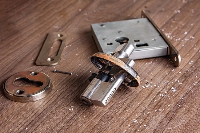 Locksmith repairing a damaged door lock in Ballwin, Missouri