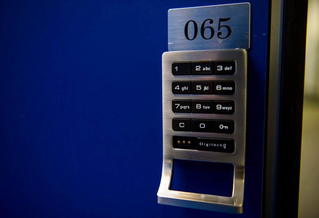 Push-button keypad lock with lever handle on a blue door