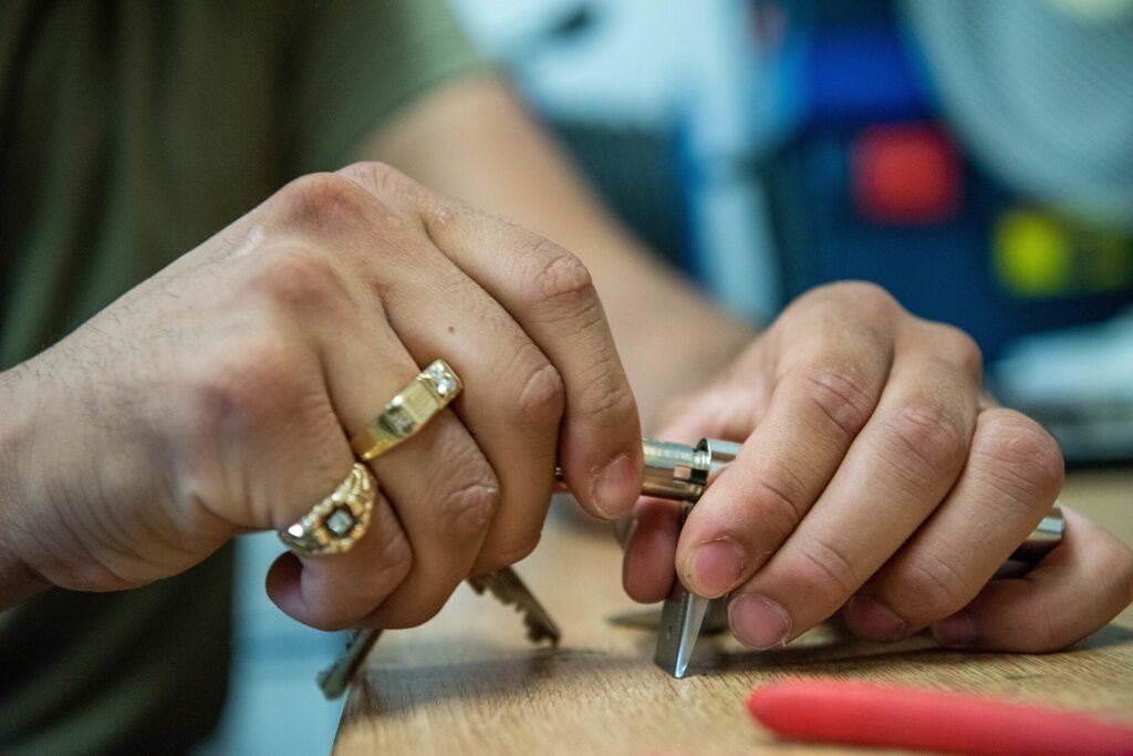 Technician taking apart a door lock cylinder to change the key
