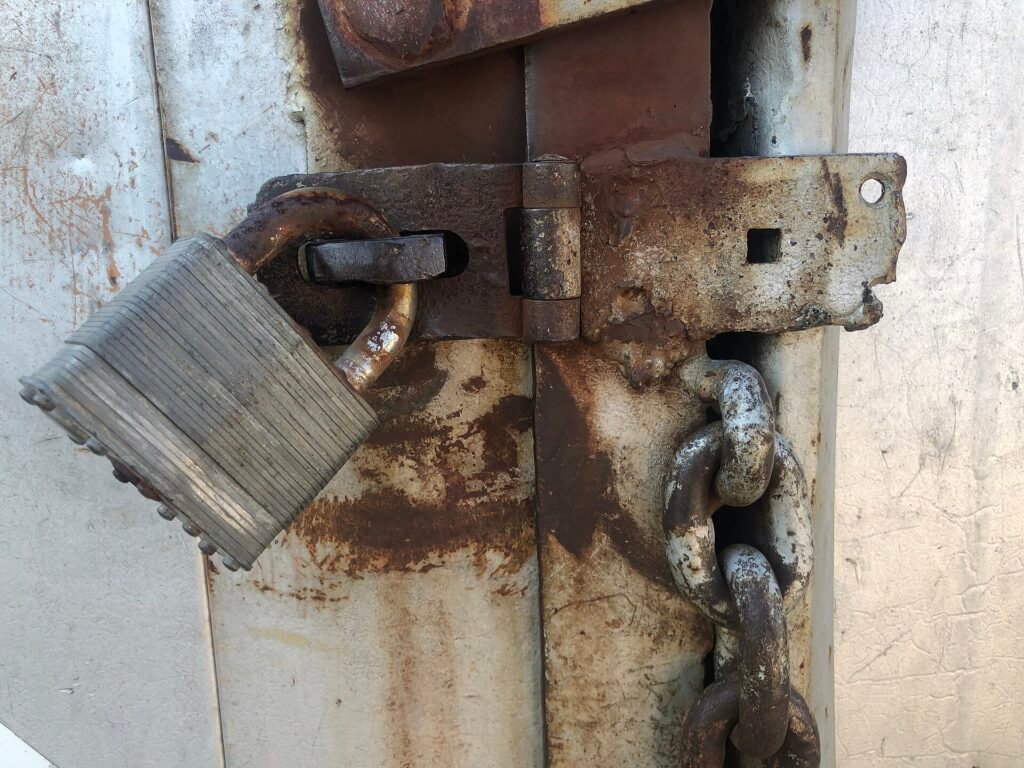 Metal door latch held shut with a padlock