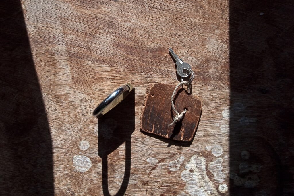 Key turned in an old padlock on a wooden door