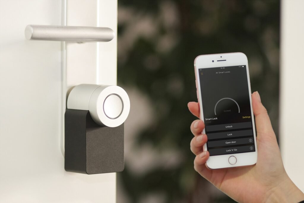 Smart lock on the inside of a door being opened with a phone app